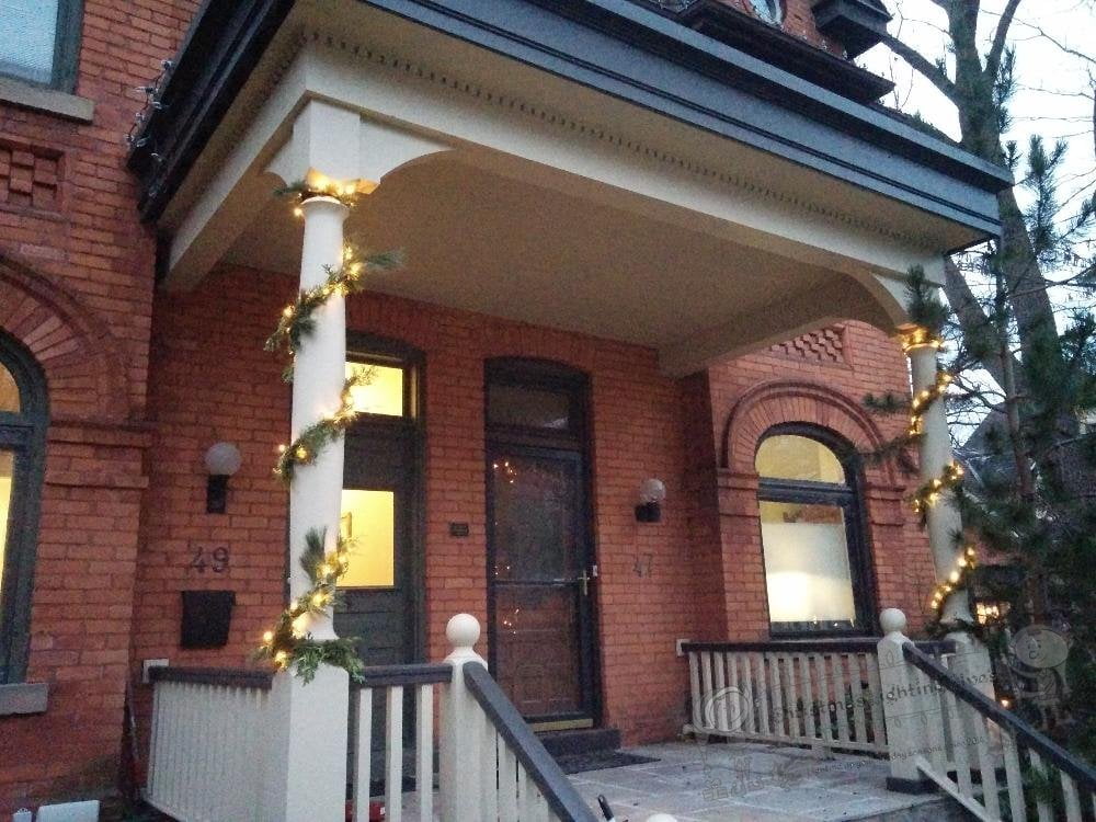 Columns of a house decorated with LED light garlands